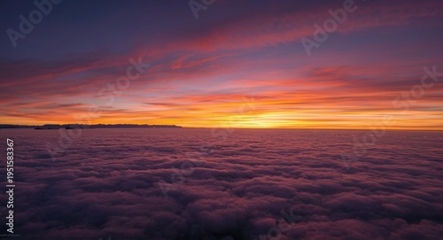 Sky high image capturing dynamic sunset above thick clouds with far off mountain ridges and empty copy space