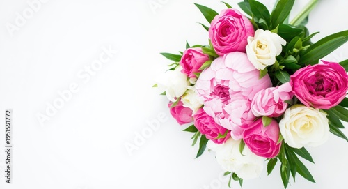 Fresh peonies and roses bouquet on simple white surface