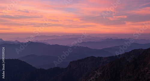 Soft pastel sunset hues enveloping sprawling mountain tops