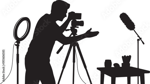 Silhouette of videographer filming product with camera and microphones