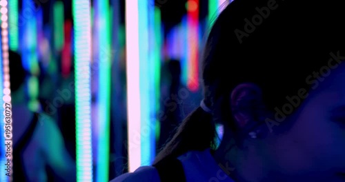 Girl Walking Mirror Maze Reflection Illusion Endless Corridors LED Lights Optical Attraction Searching Exit Surreal Experience Entertainment Space Visual Puzzle Interactive Environment