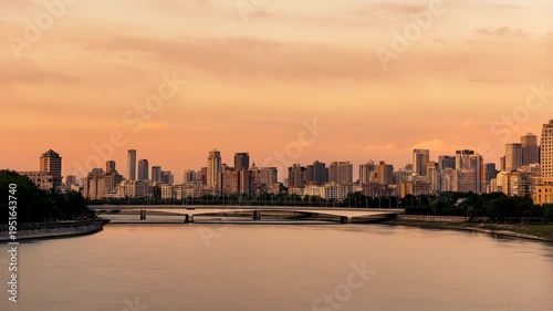 Wallpaper Mural Panning shot of city skyline moving across river with bridge during sunset golden hour light Torontodigital.ca
