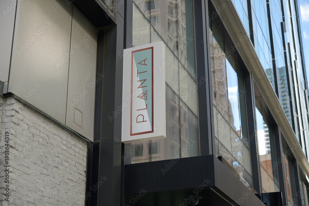 Fototapeta premium wall mounted projecting sign outside PLANTA, a vegan restaurant, located at 1221 Bay St, Toronto