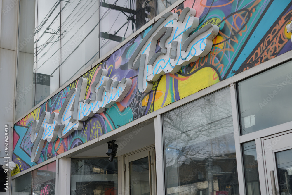 Fototapeta premium exterior building facade and sign of Yes Electric Tattoo, a tattoo shop, located at 499 Queen St W, Toronto