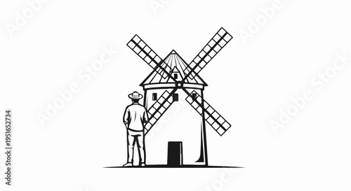 A person wearing a hat stands before a traditional windmill