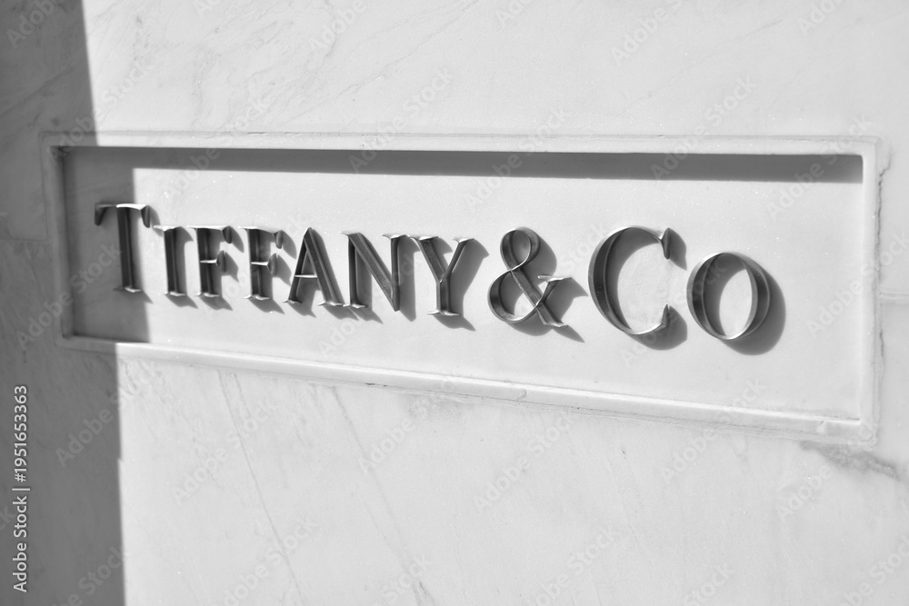 Fototapeta premium black and white view of Tiffany & Co metal on marble sign at 150 Bloor St W, inside 89 Avenue Yorkville, Toronto
