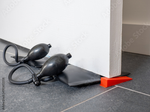 pair of air wedge pump up bags for lifting raising doors windows and equipment with rubber tubing and release valve