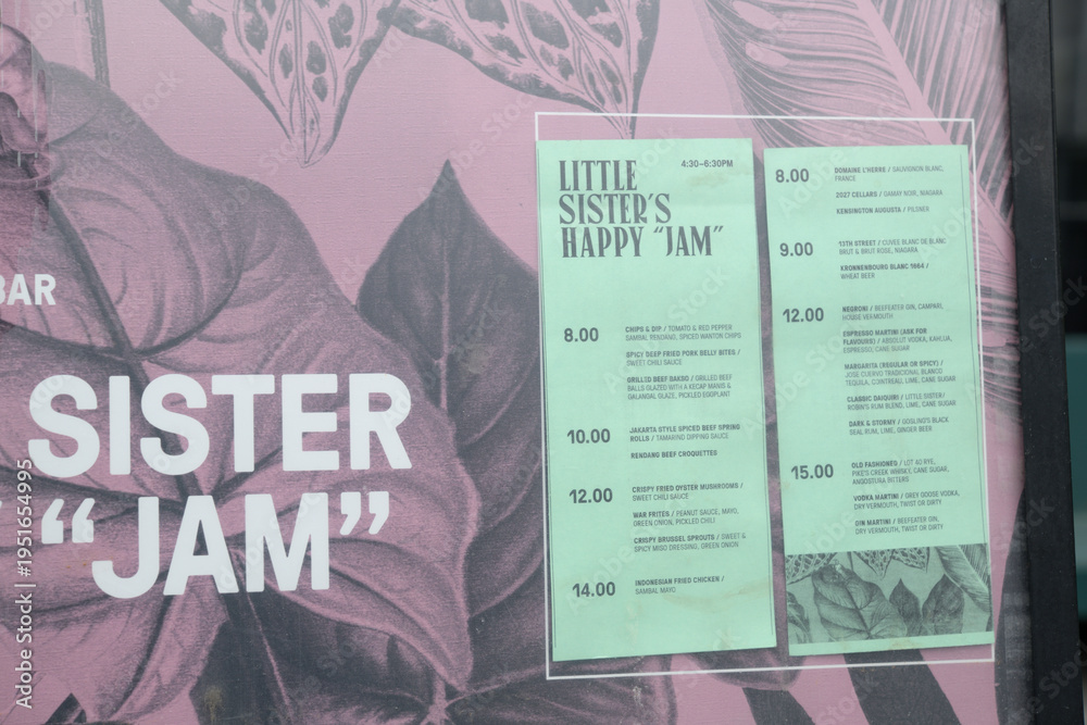 Fototapeta premium close-up of paper menu board outside Little Sister Dutch Indonesian 102 Portland St, Toronto