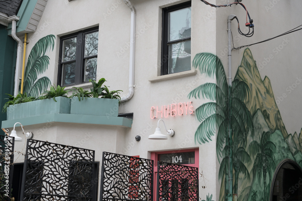 Fototapeta premium exterior building facade and sign of Chubby’s Jamaican Kitchen located at 104 Portland Street, Toronto