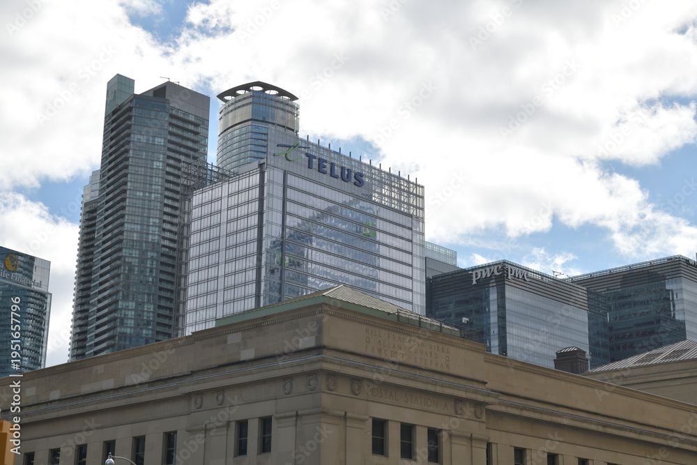 Obraz premium looking southwest to Telus Harbour and skyline sign at 25 York St from Front St W and Bay St Toronto (contrast with Post Office Department building)