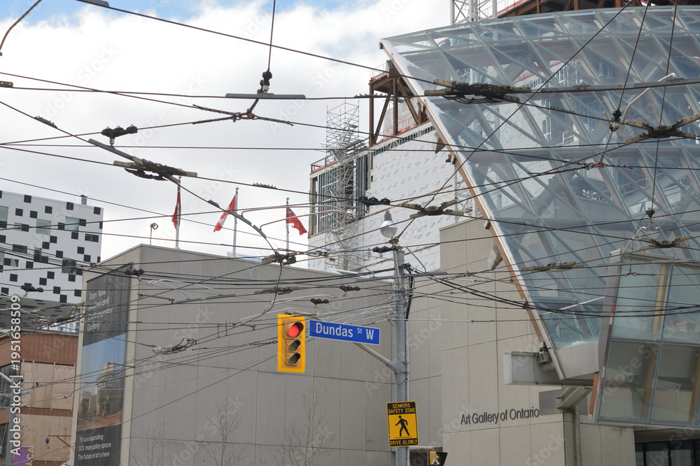 Fototapeta premium overhead transit wires and the McCaul St and Dundas St W (or eastern flank) of the Art Gallery of Ontario, Toronto