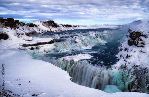 Konstfotografi Wide angle long exposure of Gullfoss waterfall in Iceland covered in snow and ice