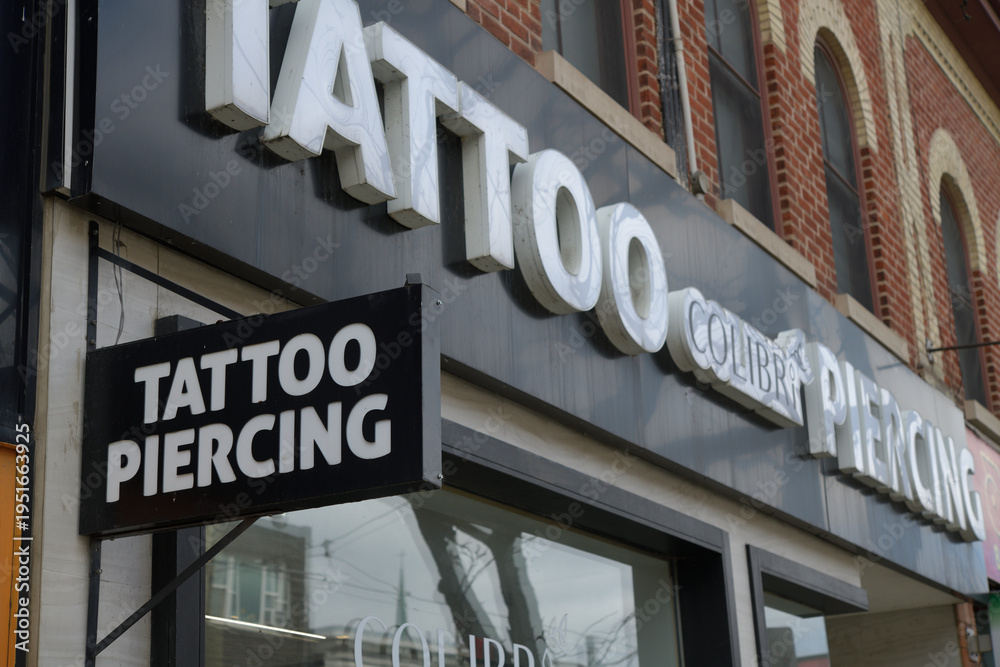 Naklejka premium exterior building facade and sign of Colibri Tattoo and Piercing located here at 519 Queen St W, Toronto