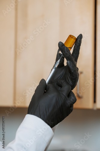 Billede på lærred Woman extracting medicine from a vile