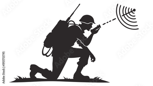 Soldier in kneeling position operating military radio communication device with antenna and backpack in a grassy field