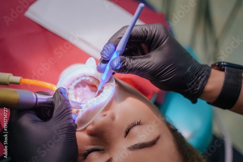 The dentist administers anesthesia to the patient. Dental treatment in a private medical clinic. The patient is injected with the drug from a syringe into the gum.
