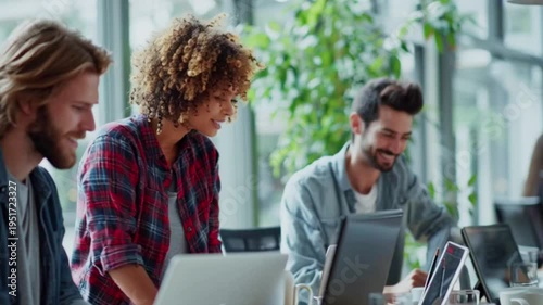 Video of three colleagues working together on laptops in a modern office