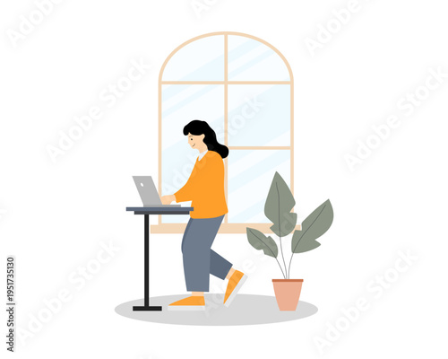 Woman standing and working on laptop at home. Remote work and modern lifestyle concept.