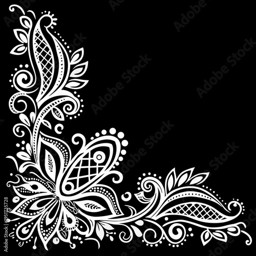 Intricate white floral and paisley corner design on a black background