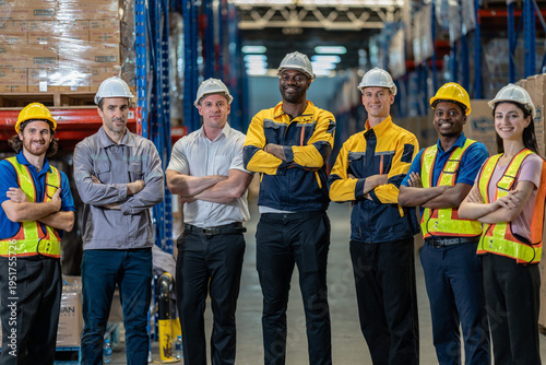 Photography Large diverse group of industrial colleagues smiling in modern storage facility aisle