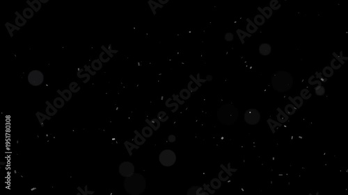 Subtle dust particles and soft bokeh lights slowly moving on a dark black background video loop