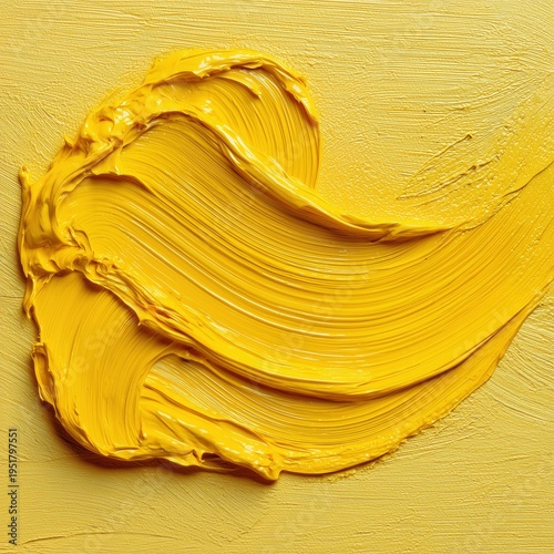 Bright Yellow Paint Applied in Flowing Strokes on a Canvas Surface
