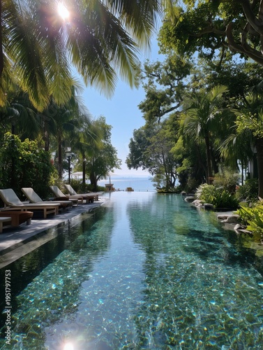 Sunny Day by the Pool With Lounge Chairs and Tropical Plants in the Background