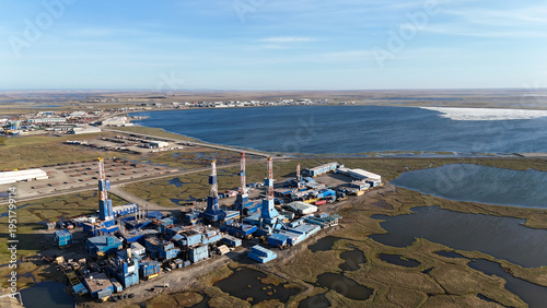 Bild auf Leinwand Oil drilling rigs and industrial facilities on prudhoe bay tundra beside icy bay