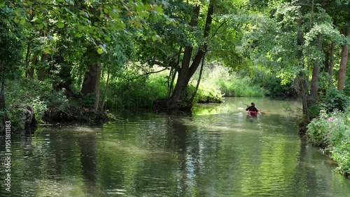 Lübbenau, Germany – Leisure kayaking on idyllic waterway between trees in the Spreewald. Suitable for sustainable tourism and recreation.