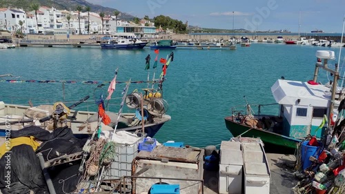 Fishing port of Las Casas de Alcanar in Catalonia, Spain. View of the boats with traditional fishing gear moored at the dock. Smooth camera movement: Panning + Track Left.