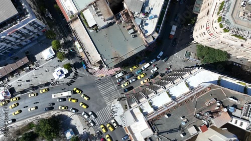 Aerial drone top down cinematic video of Athens centre dense urban landmark buildings near area of Syntagma square and Athens neoclassic trilogy in Panepistimiou street, Attica, Greece