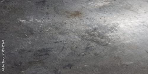 abstract shows a textured metal surface that is scratched and worn  with variations in color and light reflecting from it.