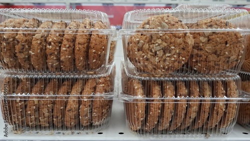 Konstfotografi Oatmeal cookies with various seeds in transparent plastic packaging on retail shelf