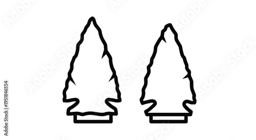 Two ancient arrowhead shapes depicted in a striking black silhouette