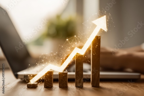 Laptop is on a table with a wooden block that has a line going up and a pointy arrow on it