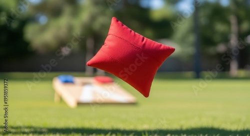 Bright red cornhole beanbag performing quick whisk through vibrant summer air. Game piece shows rapid movement with quick whisk, providing dynamic action for engaging outdoor activity.