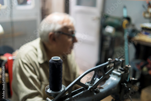 Принти на полотні Experienced Latino upholsterer meticulously repairs a backpack using a sewing ma