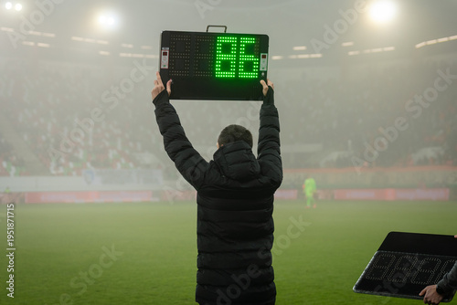 Foto Technical referee shows players substitution during football match