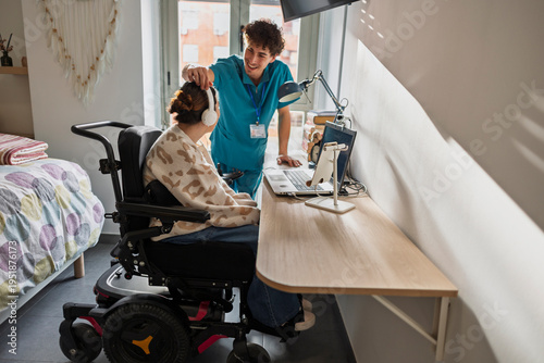 Caregiver interacting with person with disability in wheelchair