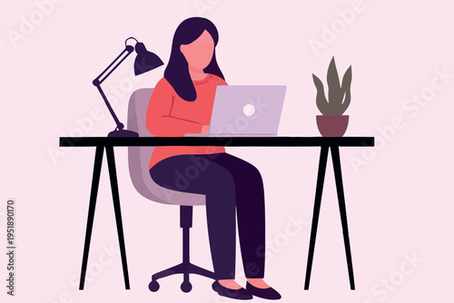 A woman working on a laptop at a desk with a plant nearby