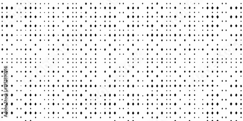 Dense arrangement of small dark shapes on a bright white background