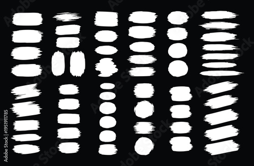 A collection of white brush strokes on a black background arranged in a grid pattern with varying shapes and sizes