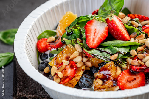 Quadro su tela Fresh fruit and nut salad with greens