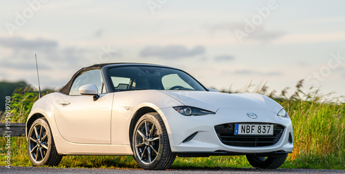 Ταπετσαρία Gothenburg, Sweden - July 25 2024: White Mazda Miata convertible parked roadside at sunset landscape