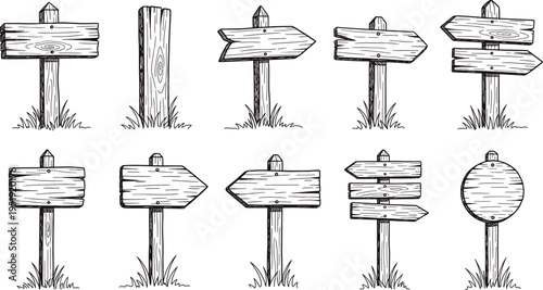 A set of wooden signs on posts with grass