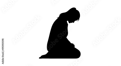 Silhouette of a kneeling woman praying.