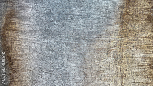 Close‑up of weathered wooden surface with fine horizontal grain lines, soft gray and brown tones, and subtle natural texture creating a rustic, minimalist background.