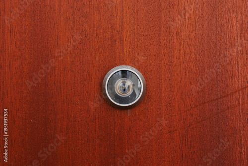 Canvastavla A centered view of a metal security peephole installed in a brown wooden door for home safety and visitor identification