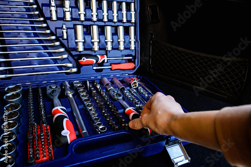 Fotografie Socket wrench toolbox in the trunk of a black car.