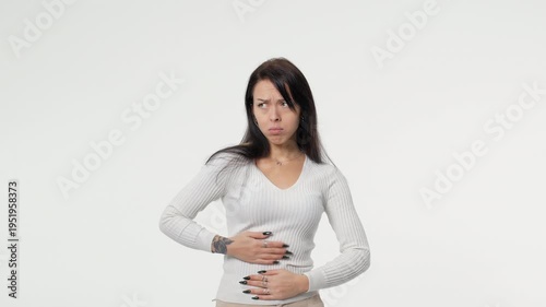 Woman had a stomach ache stomach and squeezed it to relax and soothe female menstrual cramps on isolated white background